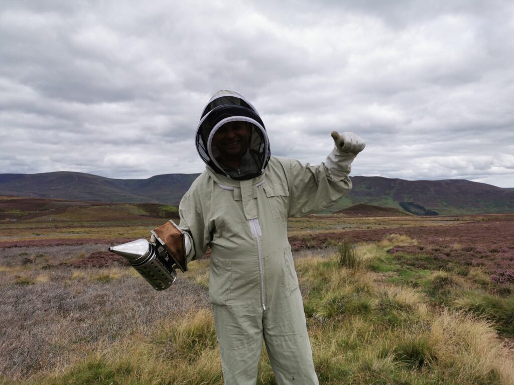 Arbuckles beekeeper with a smoker on the heather moor Arbuckles Farm Shop An arbuckles beekeeper with a smoker giving a thumbs up on the heather moor